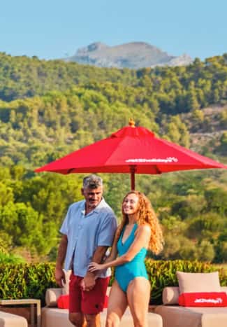 A couple walking past a pool